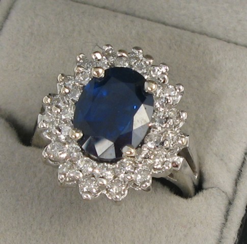 Appraisal: SAPPHIRE DIAMOND AND FOURTEEN KARAT GOLD DINNER RING Centered within