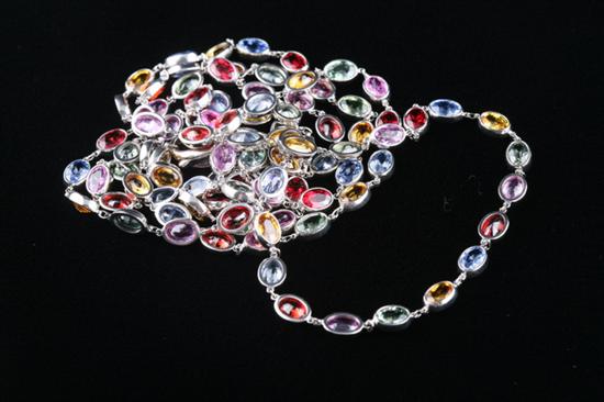 Appraisal: K WHITE GOLD AND MULTI-HUED SAPPHIRE NECKLACE Bezel-set oval sapphires