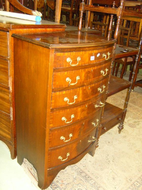 Appraisal: A reproduction mahogany bow front chest of drawers with cross