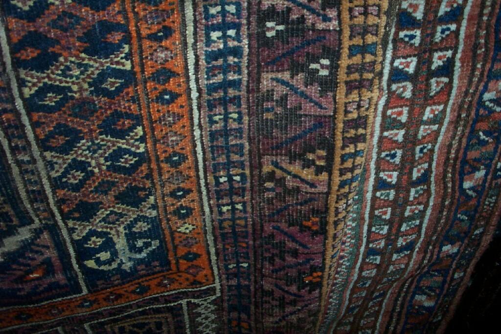 Appraisal: Two Eastern wool rugs both with polychrome geometric decoration within