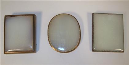 Appraisal: Three Chinese glass simulated white jade and brass buckleslate th