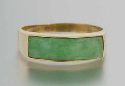 Appraisal: A Jadeite Saddle Ring k yellow gold ring set across