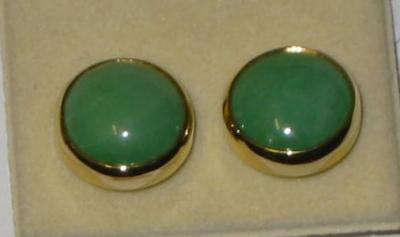 Appraisal: A PAIR OF GREEN JADEITE CIRCULAR STUD EARRINGS set in