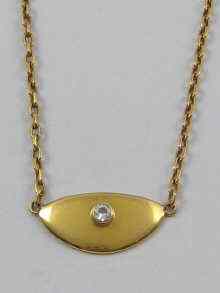 Appraisal: An ct gold semi circular pendant set with a diamond