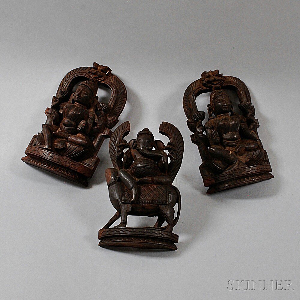 Appraisal: Three Indian Wood Carvings a pair depicting Avalokitesvara seated on