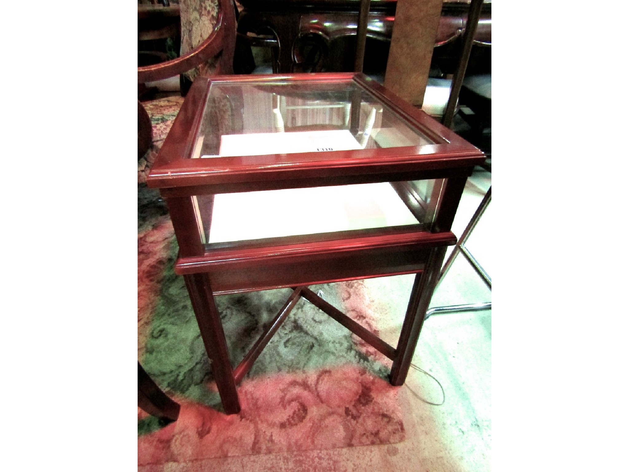 Appraisal: A reproduction mahogany low floorstanding vitrine bijouterie table the shallow