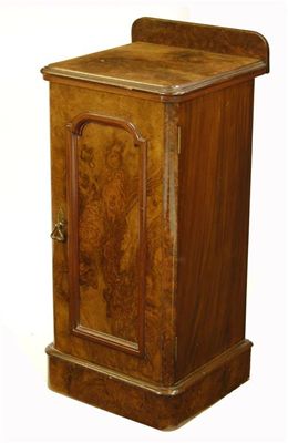 Appraisal: A Victorian walnut bedside cupboard with a panelled door enclosing