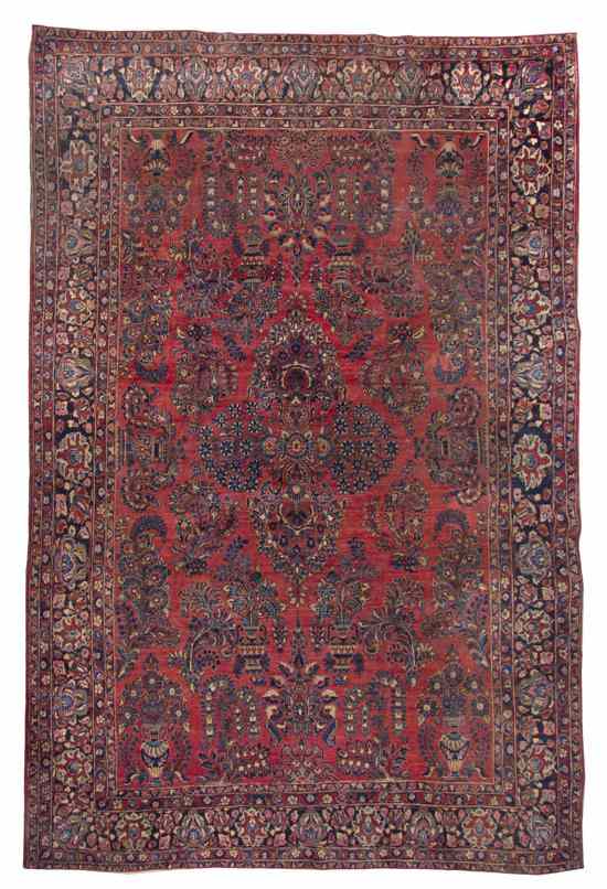 Appraisal: A Sarouk Wool Rug having a foliate center medallion surrounded