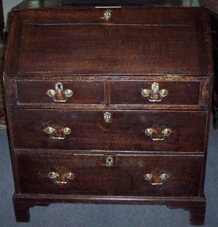 Appraisal: A George III oak bureau the fall enclosing a fitted