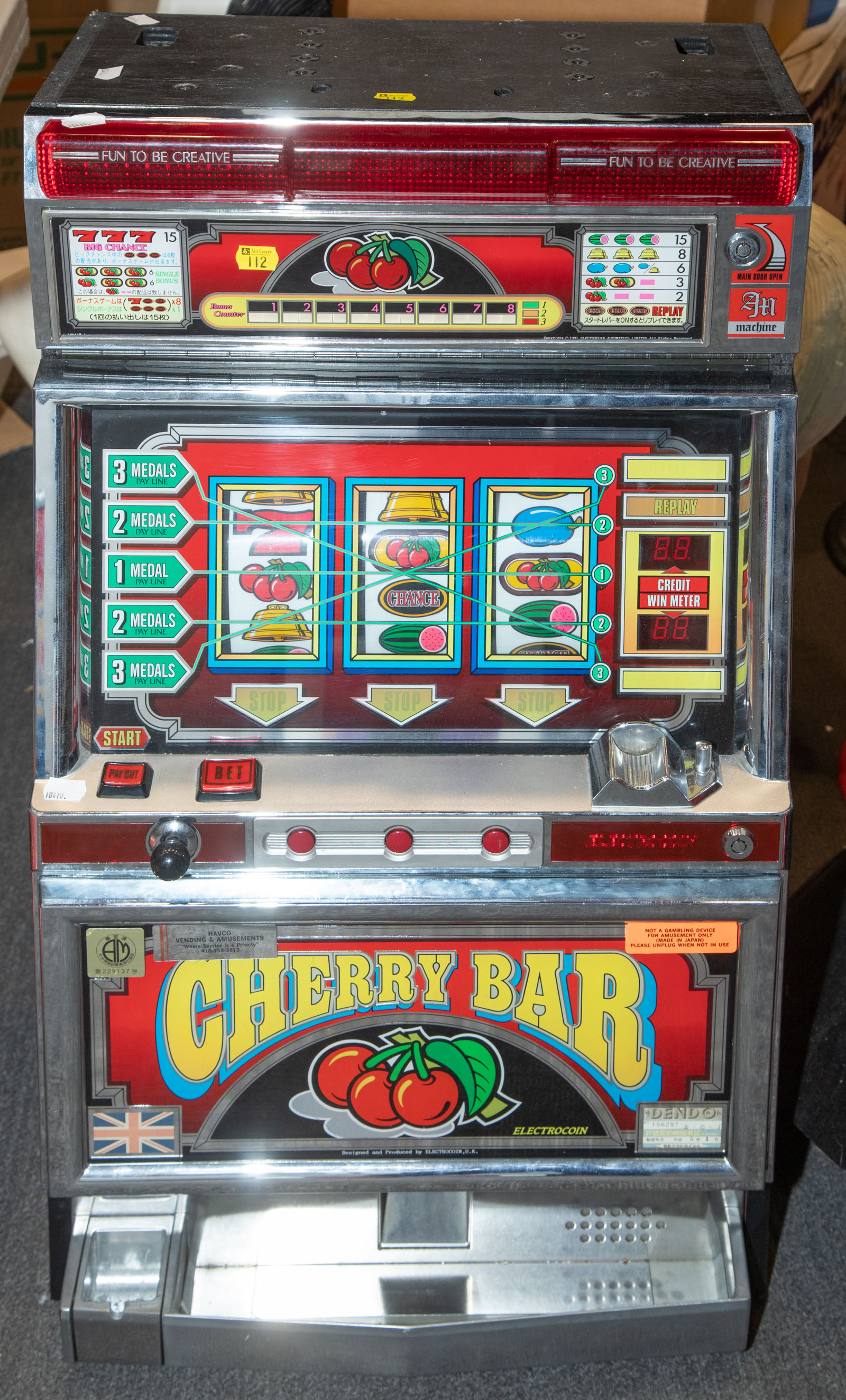 Appraisal: JAPANESE CHERRY BAR TOKEN SLOT MACHINE With tokens in H