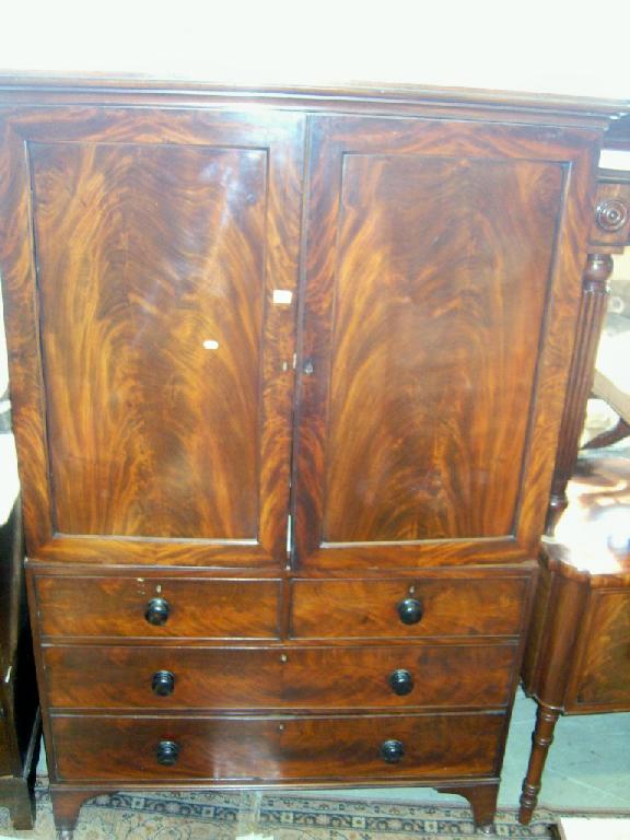 Appraisal: A Regency mahogany linen press the base enclosed by long