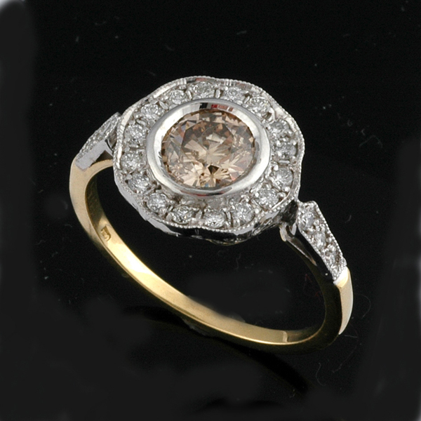 Appraisal: A COGNAC DIAMOND CLUSTER RING The round brilliant cut cognac