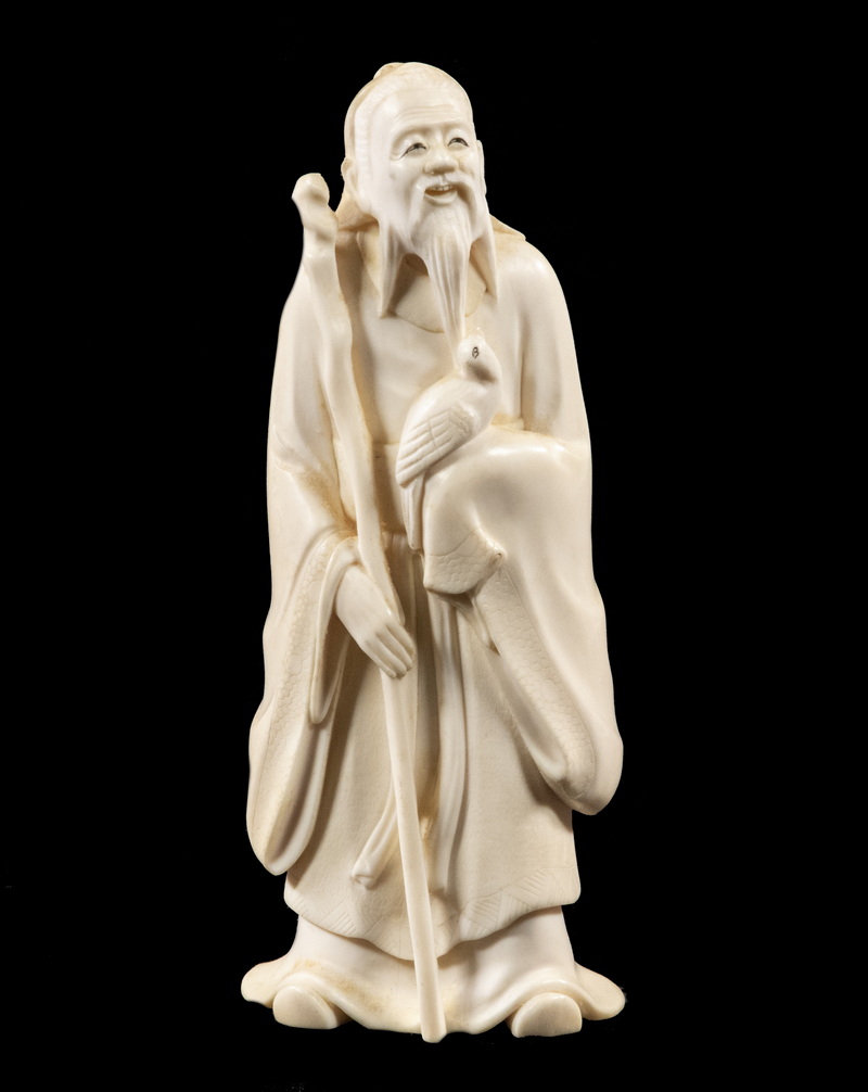 Appraisal: TH C JAPANESE IVORY FIGURINE Okimono of a Traveling Scholar