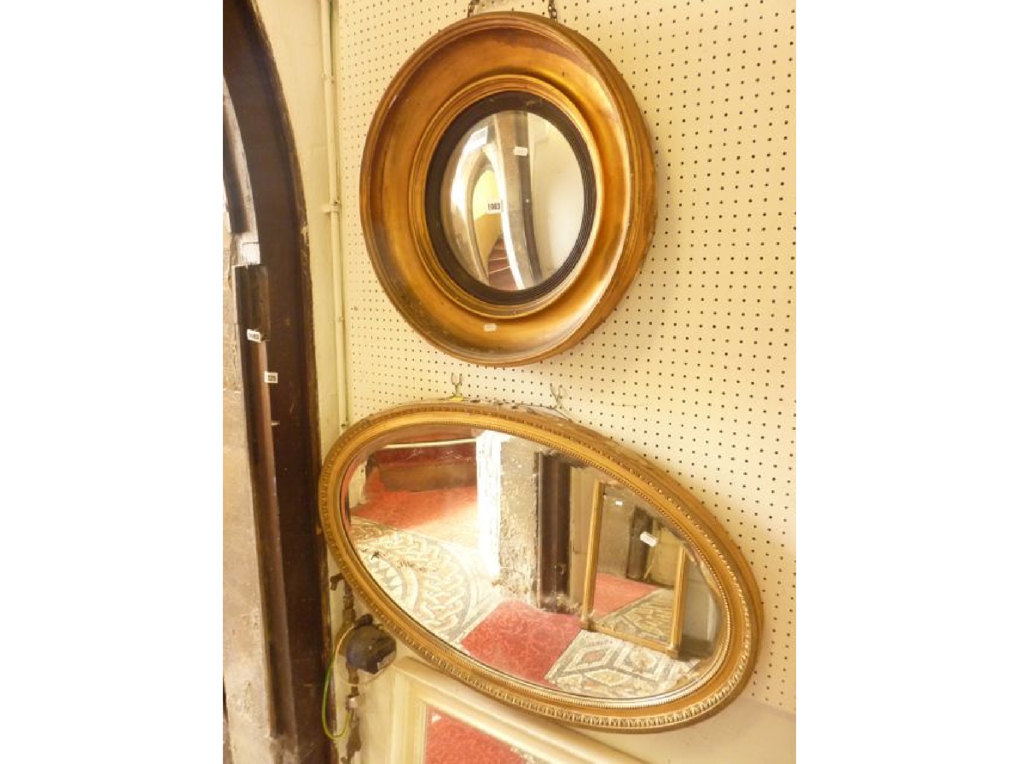 Appraisal: A th century gilt framed convex wall mirror with ebonised