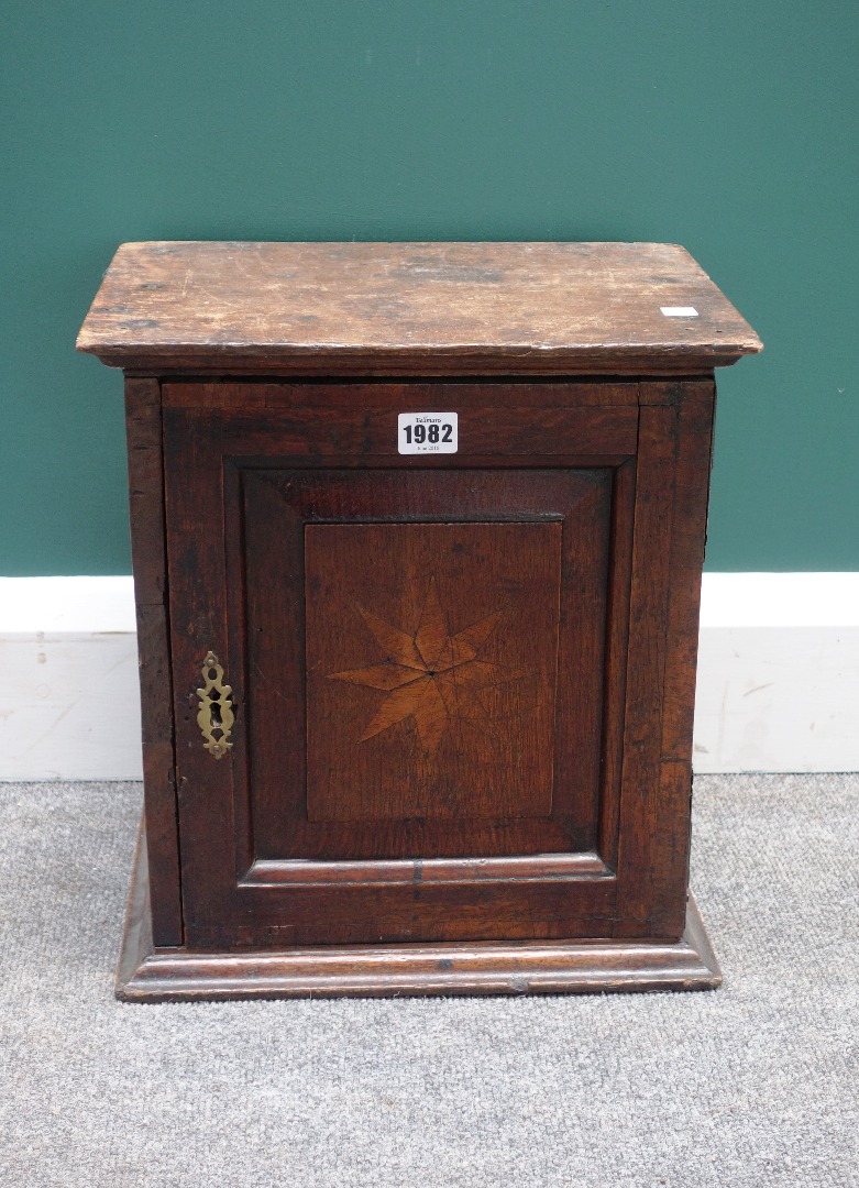 Appraisal: A small Charles II and later oak spice cupboard with