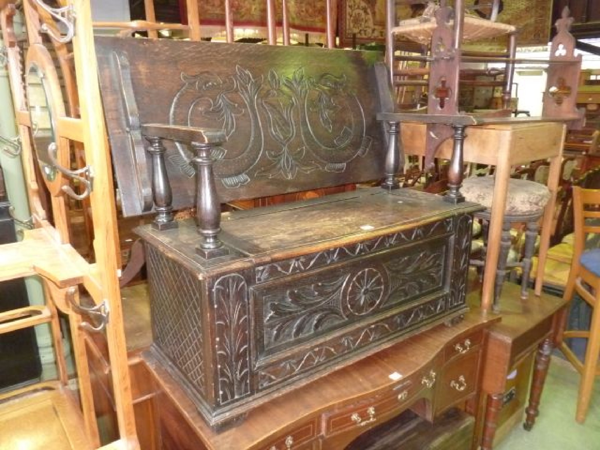 Appraisal: A Victorian oak monks bench settle with carved detail the