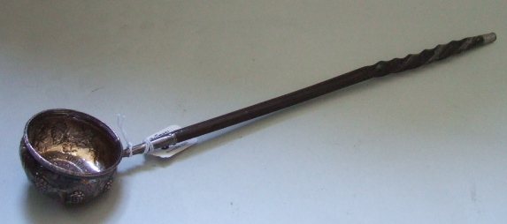 Appraisal: A silver toddy ladle embossed with fruting vine and mounted