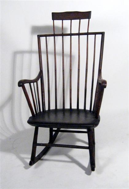 Appraisal: Comb-back Windsor rocking chair th century With seven spindle back