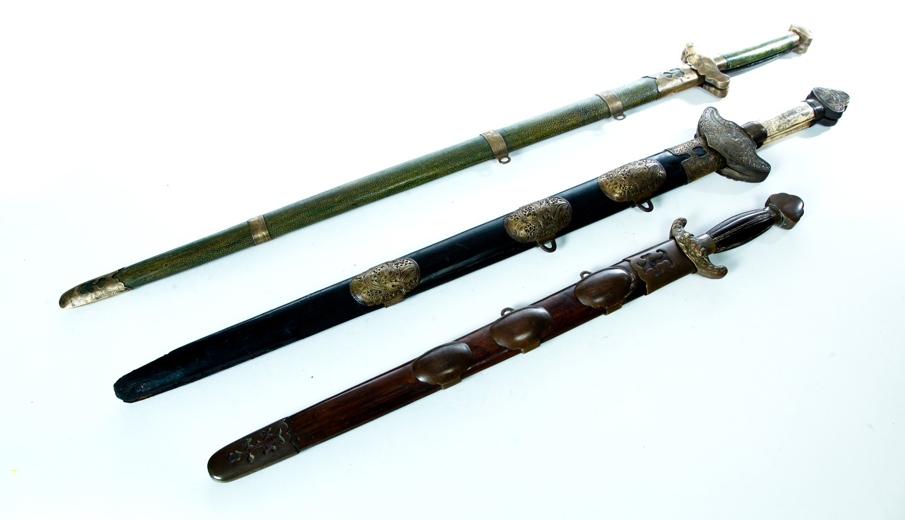 Appraisal: THREE CHINESE SWORDS Twentieth century One single edge in wooden