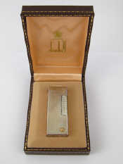 Appraisal: A Dunhill silver plate lighter unused in original box and