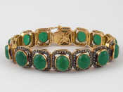 Appraisal: A yellow metal tests carat gold cabochon green hardstone and