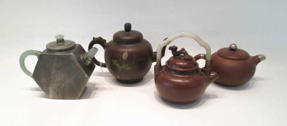 Appraisal: FOUR ZISHA TEAPOTS including one with pewter exterior one with