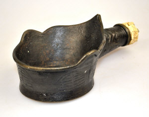 Appraisal: An oriental bronze scoop with short handle and carved ivory