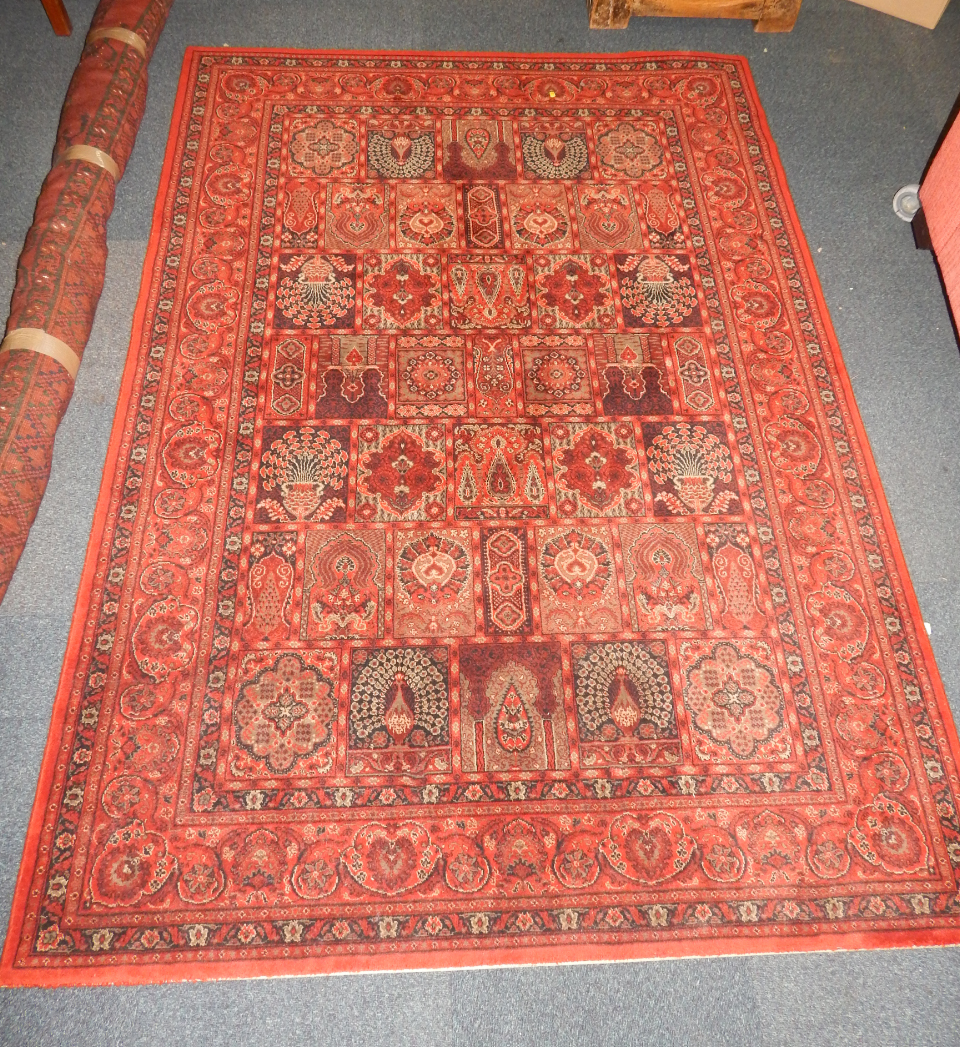 Appraisal: A Caucasian red ground rug decorated with panels of peacocks