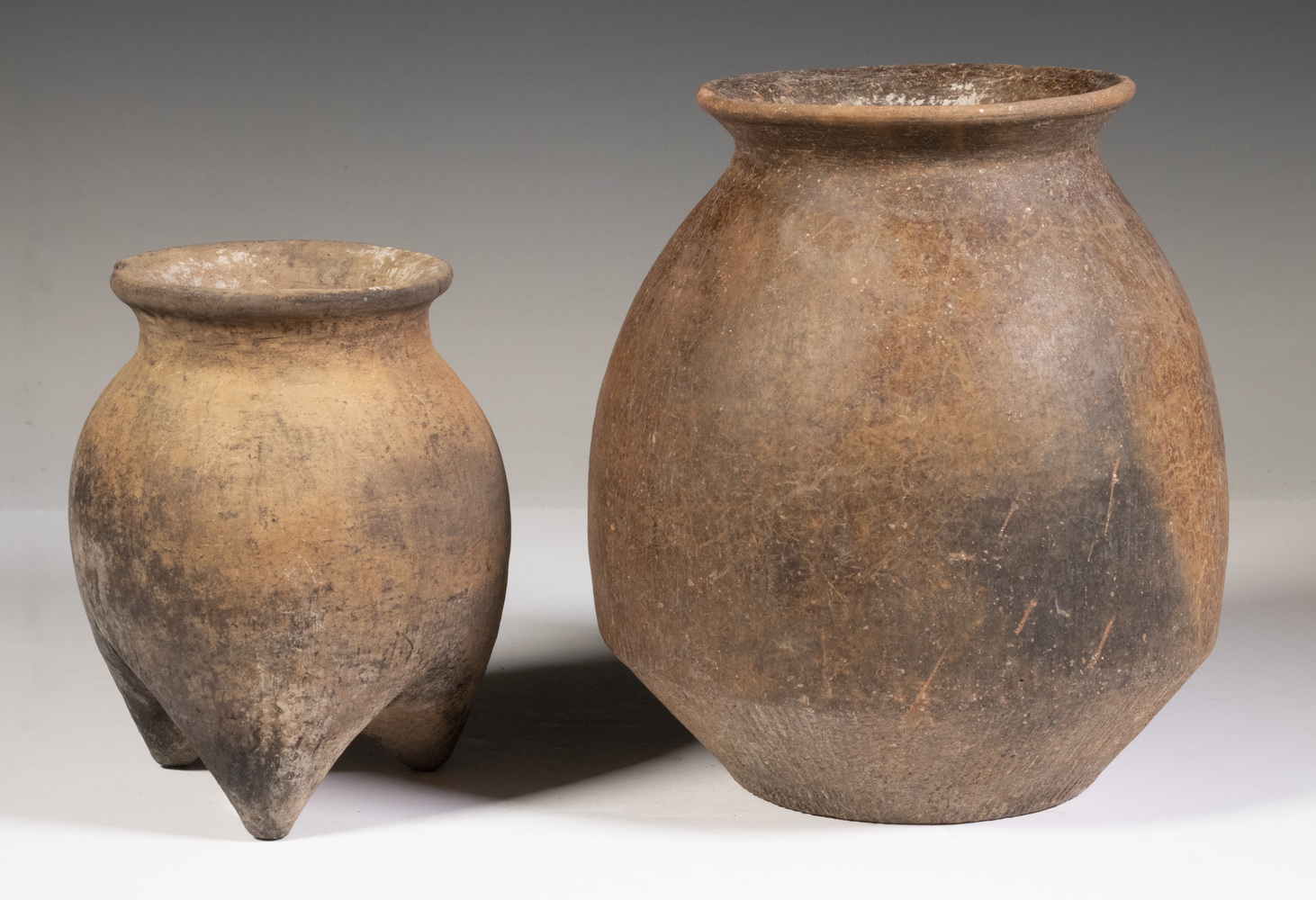 Appraisal: CHINESE ARCHAIC CLAY POTS Both in terracotta including a three-footed