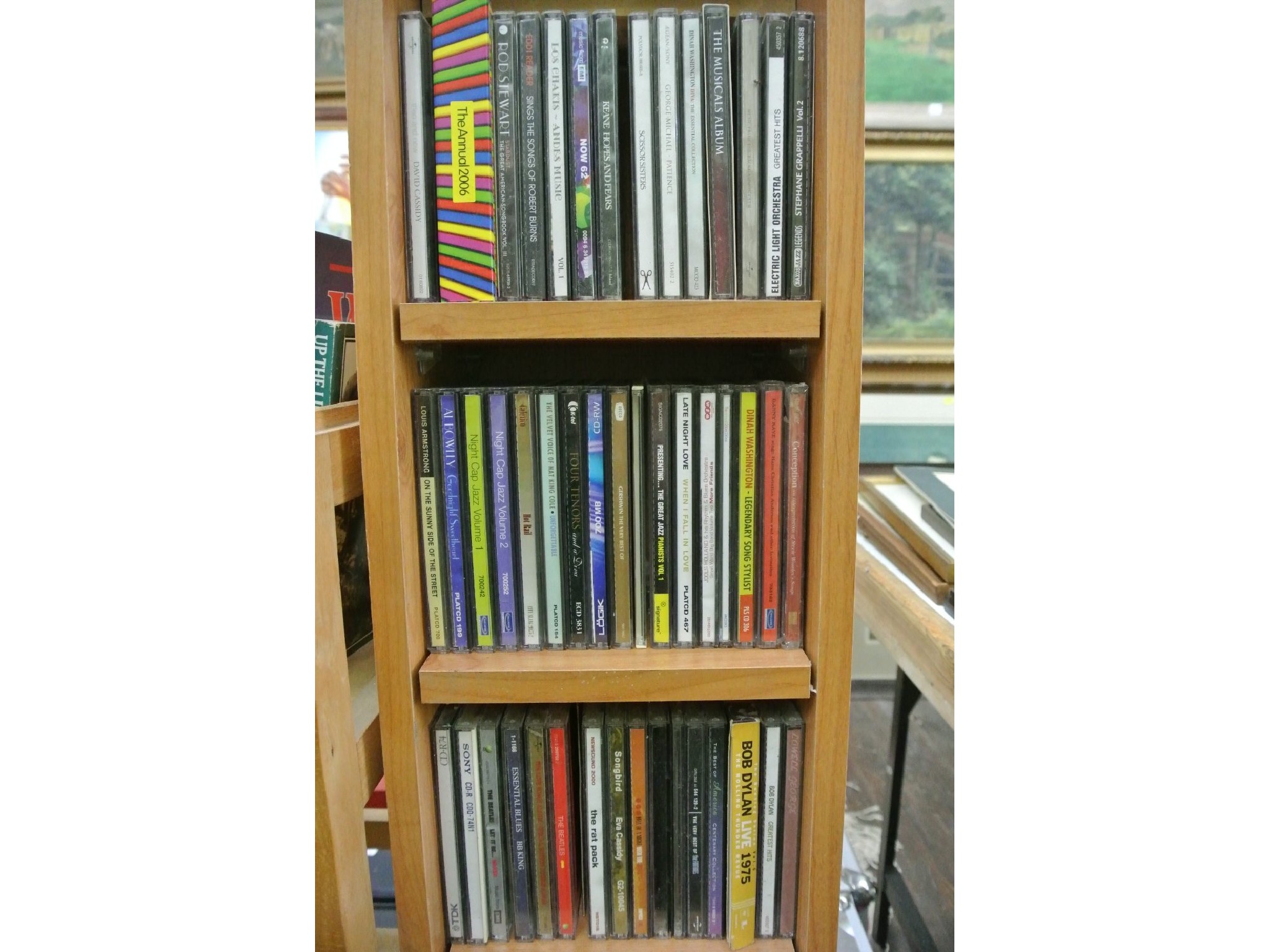 Appraisal: A free standing CD holder containing a quantity of mixed