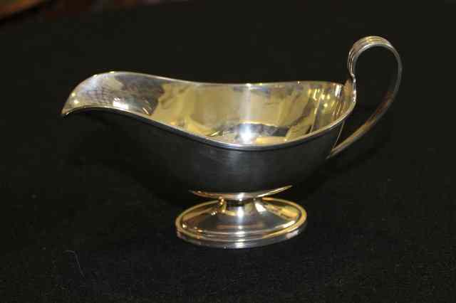 Appraisal: A SILVER SAUCE BOAT with pedestal foot reeded border and