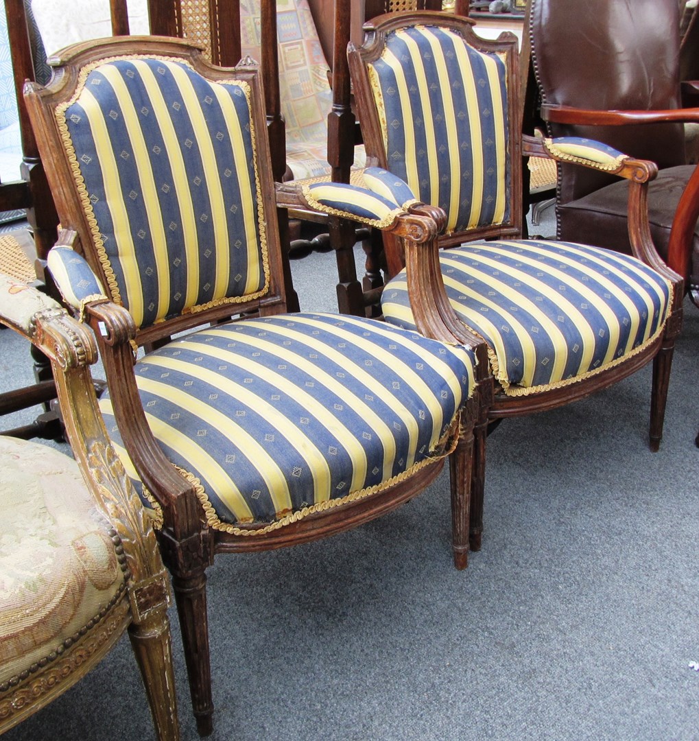 Appraisal: A pair of th century walnut framed fauteuils on tapering