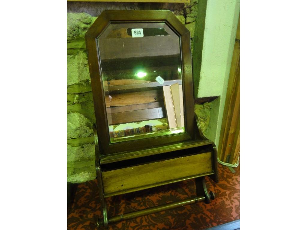 Appraisal: A small mahogany wall mounted vanity mirror with bevelled plate