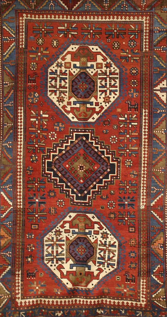 Appraisal: Kazak Rug Circa Red ground with rosette and geometric field