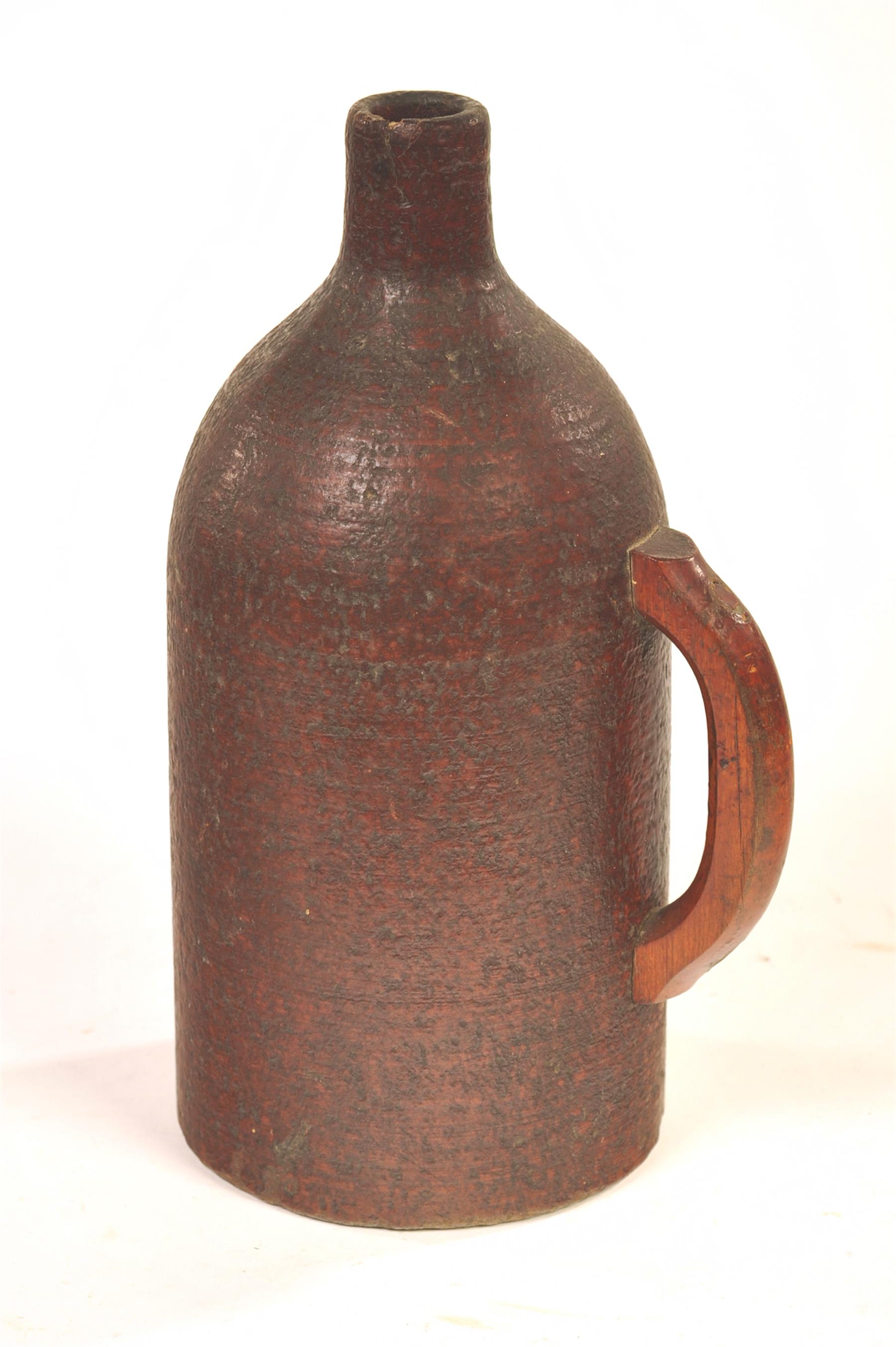 Appraisal: PRESSED WOOD POWDERED FLASK American ca Jug-shaped with wood handle