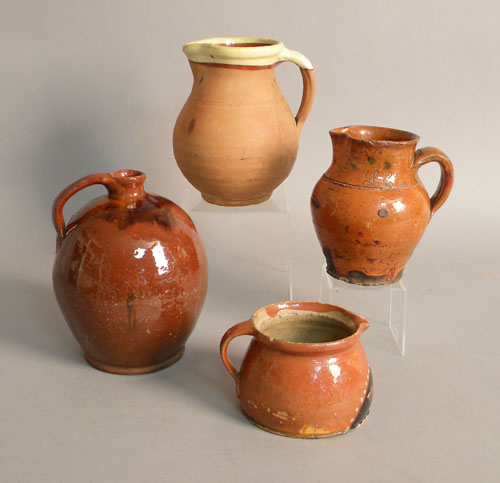 Appraisal: Redware jug with orange and brown glazing h together with