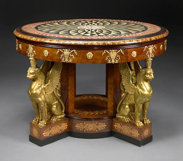 Appraisal: An imposing Empire style gilt bronze mounted inlaid amboyna center