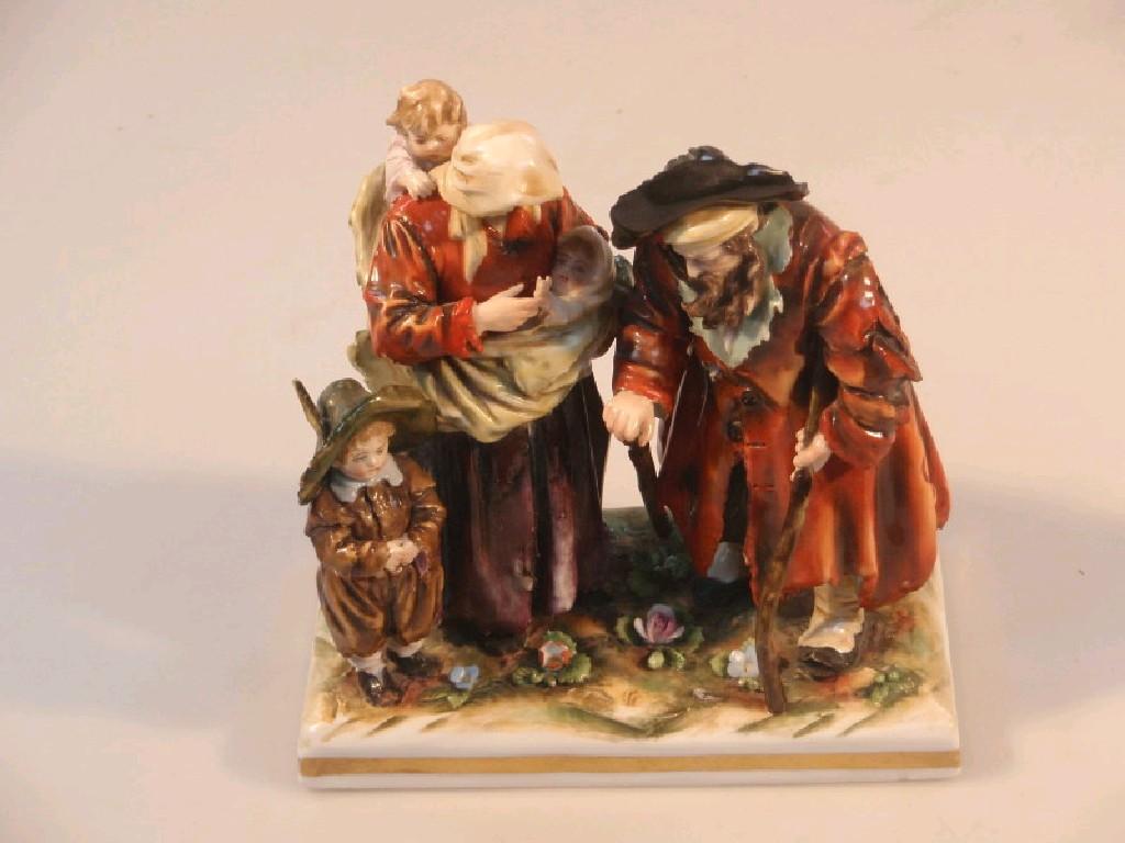 Appraisal: An Austrian porcelain polychrome figure group of a beggar and