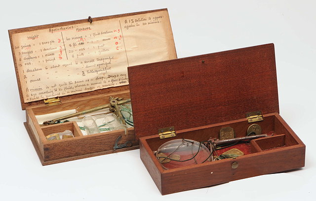 Appraisal: A MAHOGANY CASED APOTHECARY'S BALANCE with steel balance arm strings