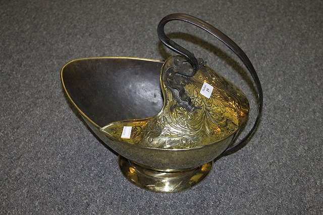 Appraisal: A BRASS COAL SCUTTLE in the manner of Christopher Dresser