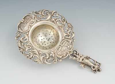 Appraisal: A Decorative German Silver Tea Strainer The relief decorated and