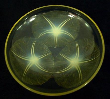 Appraisal: A Lalique shallow bowl of Lys pattern in amber tinted