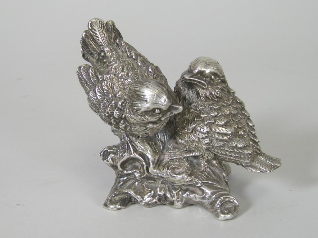 Appraisal: A Continental silver Model of two love birds on naturalistic