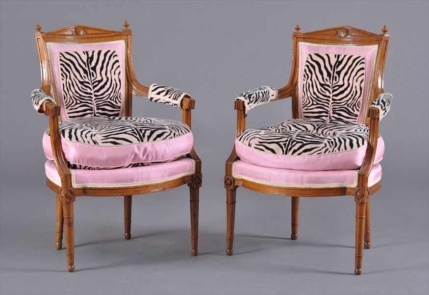 Appraisal: PAIR OF DIRECTOIRE CARVED WALNUT FAUTEUILS EN CABRIOLET Each padded