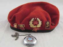 Appraisal: A soviet Russian red beret with badges together with a