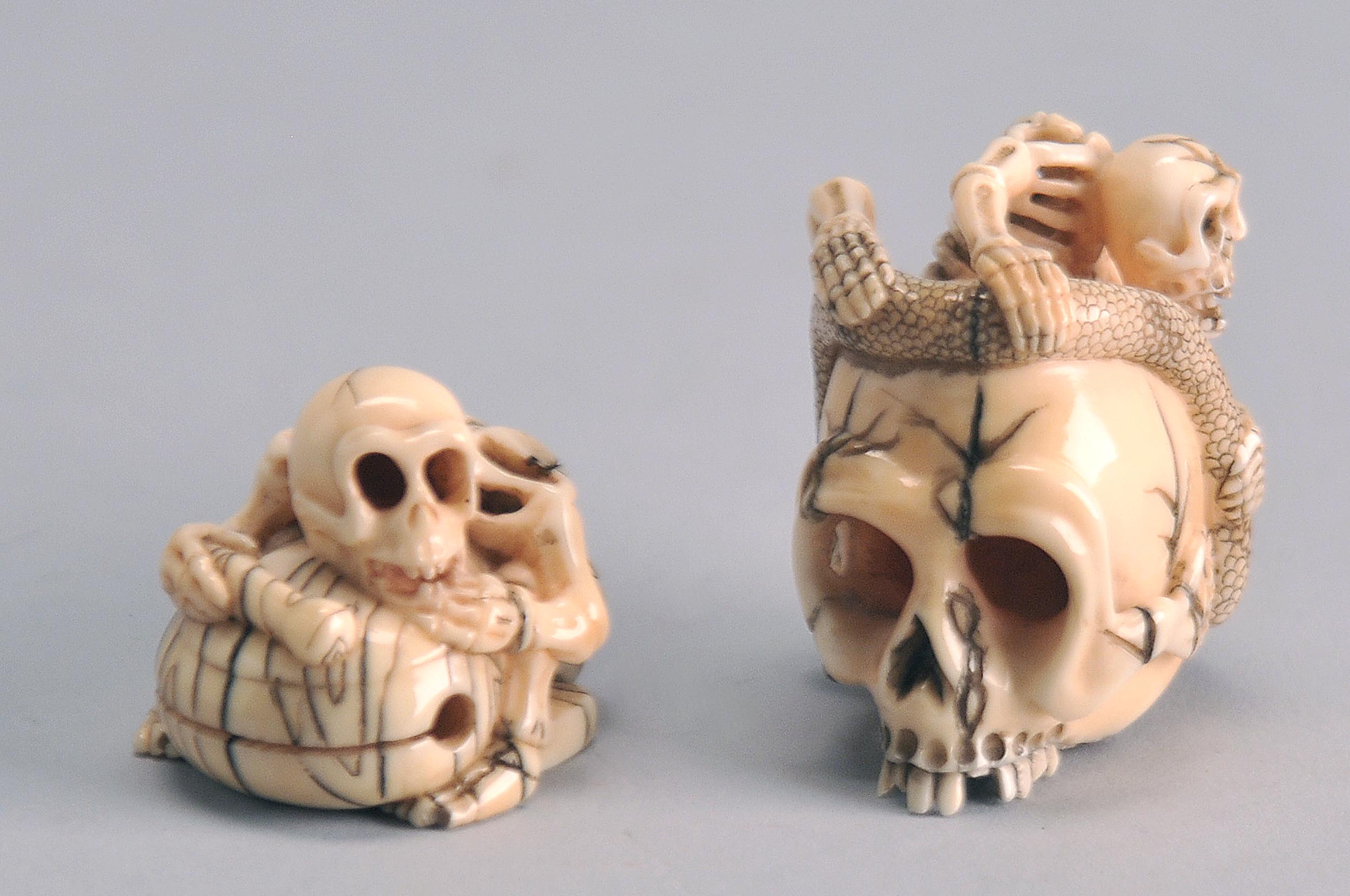 Appraisal: TWO IVORY NETSUKE Early th CenturySkeleton with mokugyo bell and