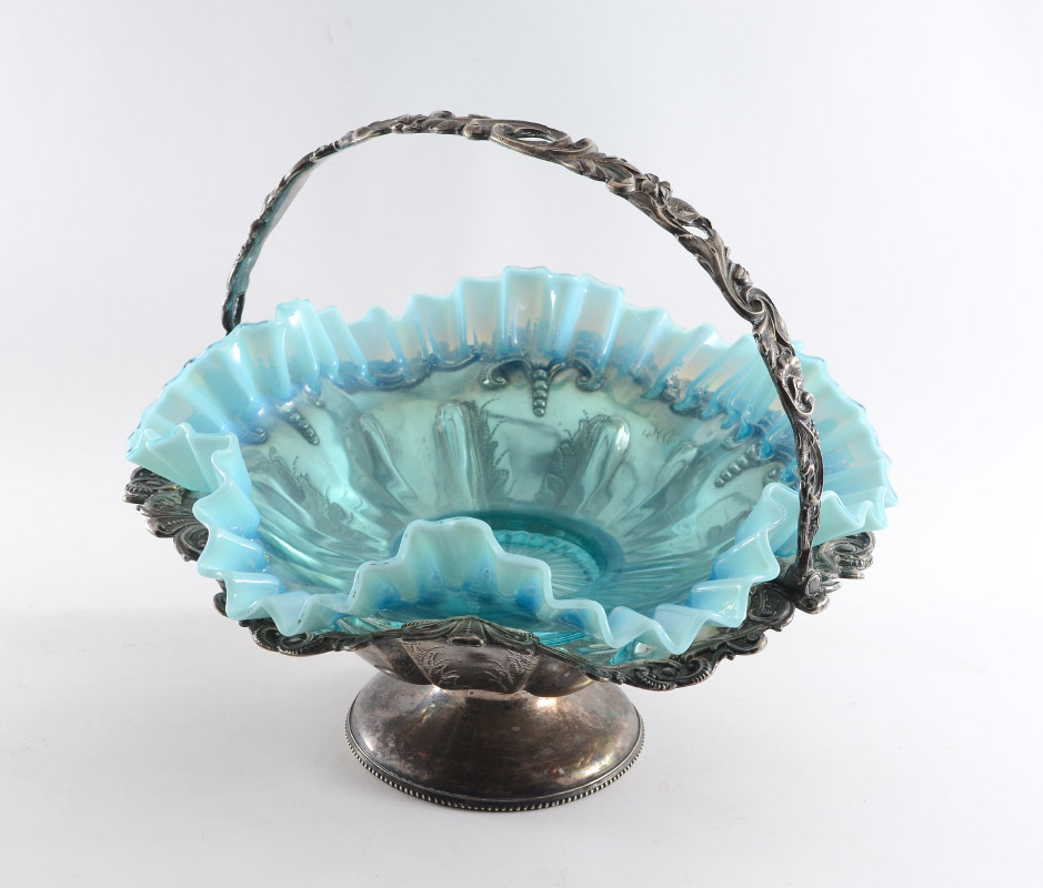 Appraisal: VICTORIAN BRIDES BASKET Ruffled blue iridescent glass bowl silverplate holder