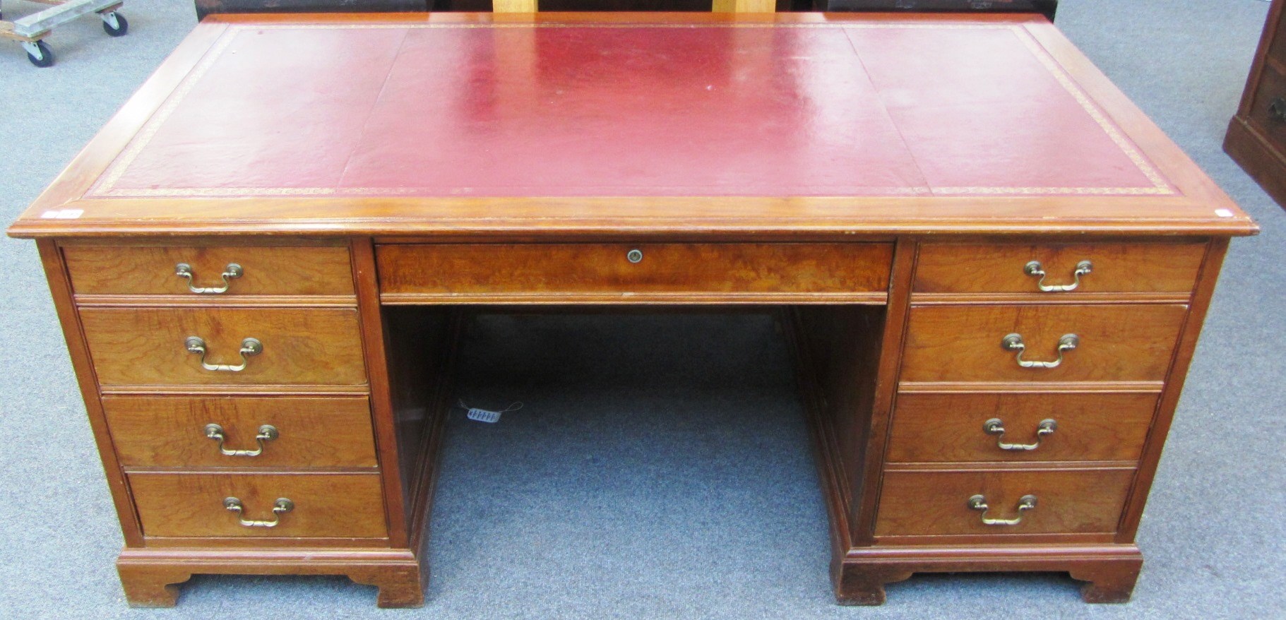 Appraisal: An th century style mahogany pedestal desk with nine drawers