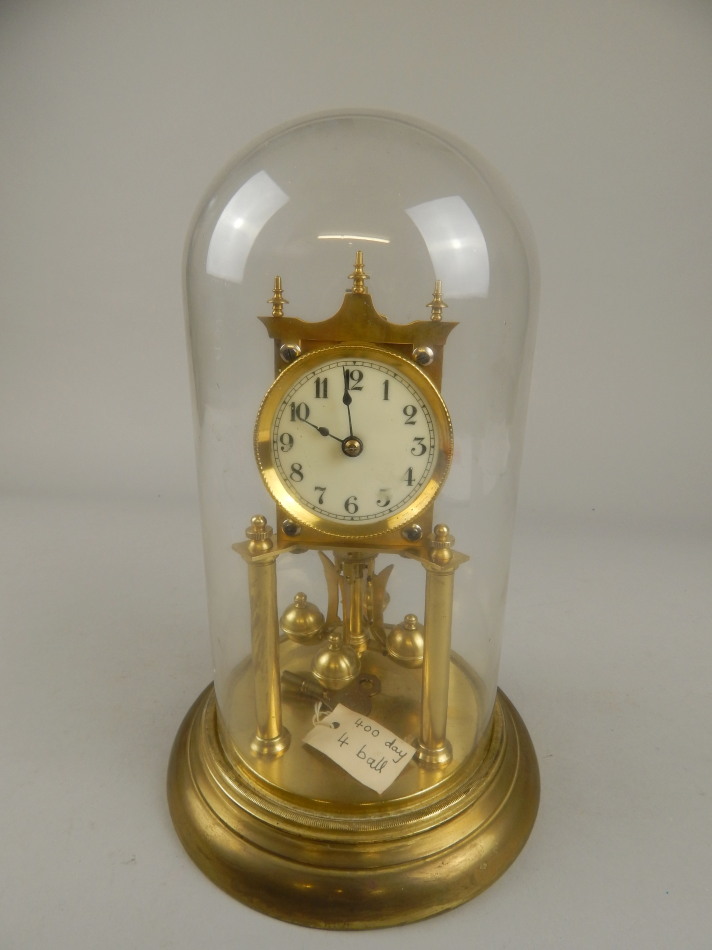 Appraisal: A early thC brass anniversary type clock with enamelled dial