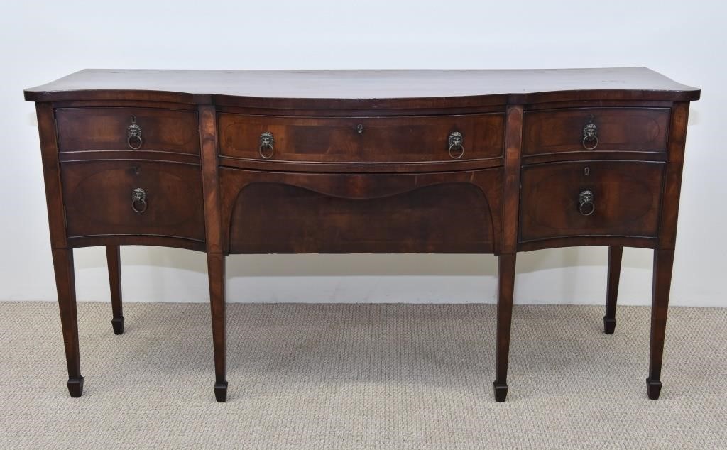 Appraisal: Georgian mahogany inlaid serpentine front sideboard circa with brass lion